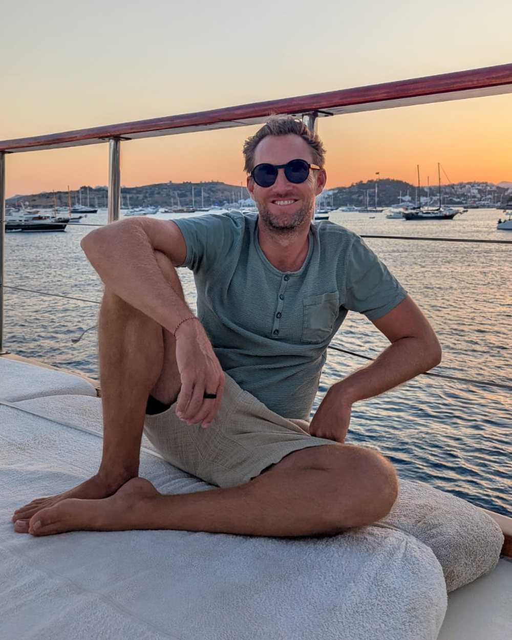 Brady, founder of Xpand Yachts, aboard a yacht at sunset in Bodrum